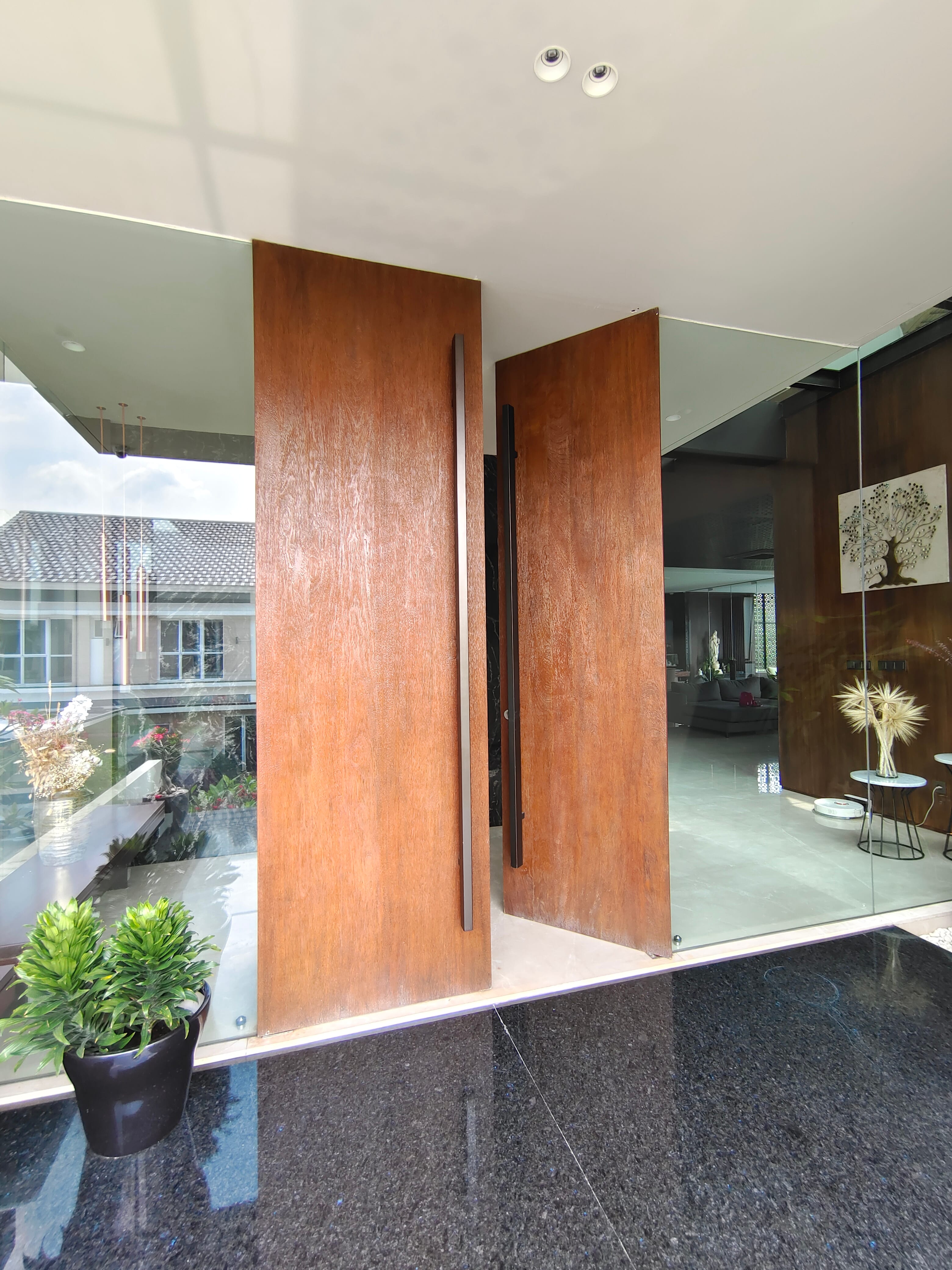 Solid wood pivot doors at Jakarta Garden City private residence by Reywood