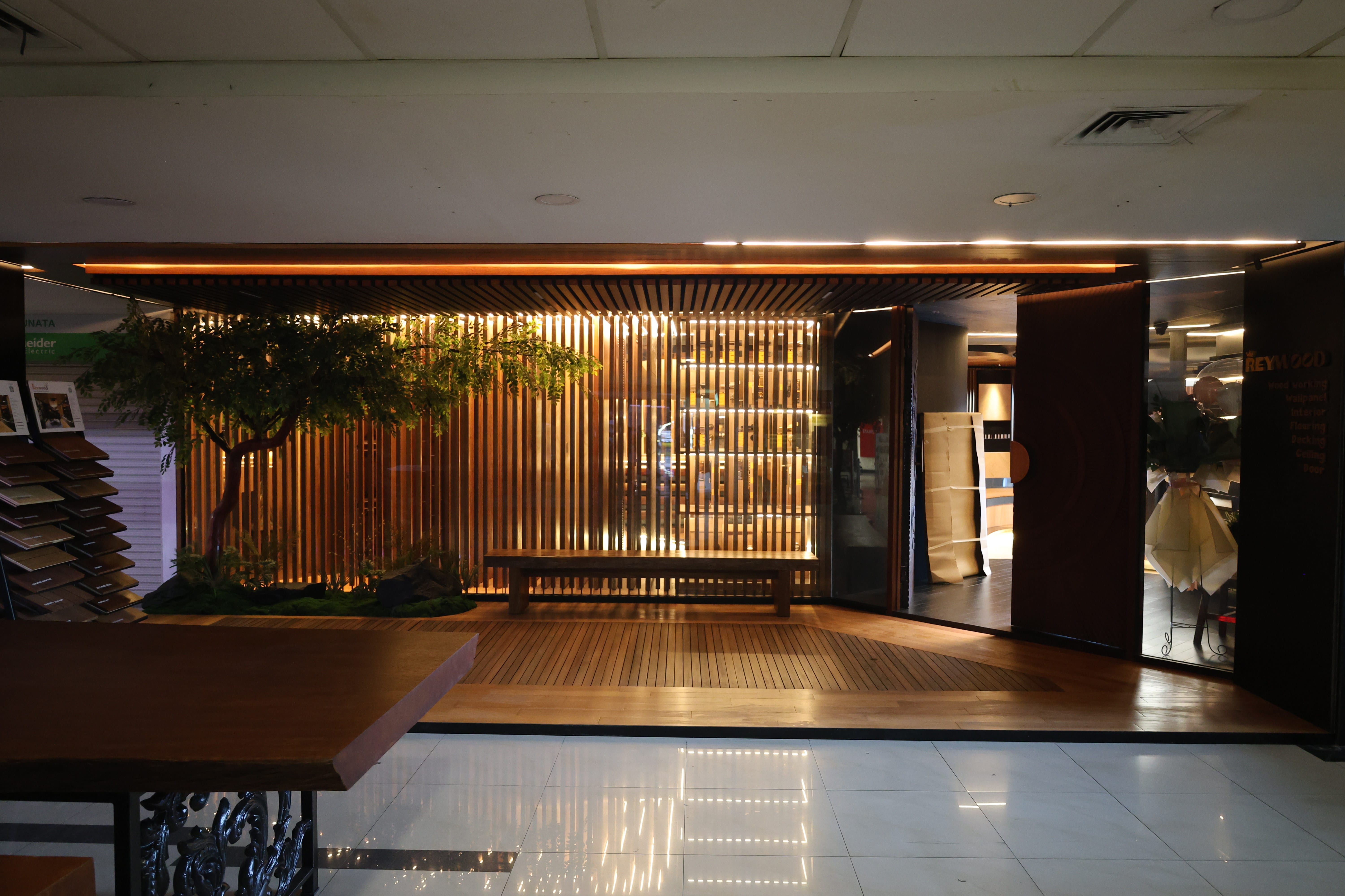 Reywood Indonesia showroom exterior entrance with kisi-kisi facade and decking floor at Plaza Kenari Mas Jakarta